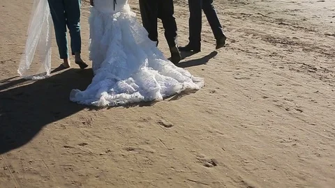 Bride walk with friends on the beach Video stock 72324126