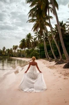 Bride Walking on the Beach Stock Photos