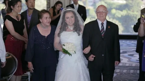 Bride walking down aisle with father at wedding Stock Footage 46063936