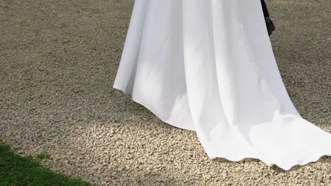 Bride Walking Outdoors in Elegant Wedding Dress on Gravel Path Video stock 345020729