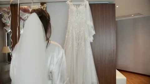 The bride is walking towards her wedding dress 스톡 동영상 141777758