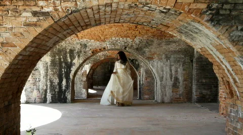 Bride Walking Under Brick Arches Video stock 673644