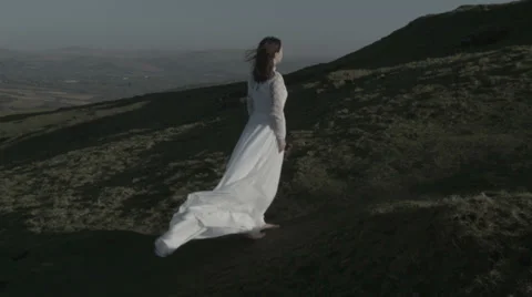 Bride walking up windy hill v4 Stock Footage 38844251