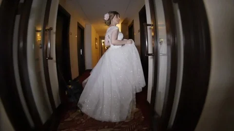 The Bride Walks Down a Long Corridor Stock Footage 123515565