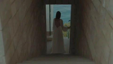 Bride walks down the stairs to the blue sea Stock Footage 232854331