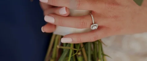 Bride Wearing Her Wedding Wedding Ring and Holding Flowers. Slow Motion Stock Footage 126613706
