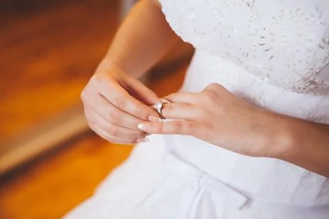 Bride wearing wedding ring Stock Photos