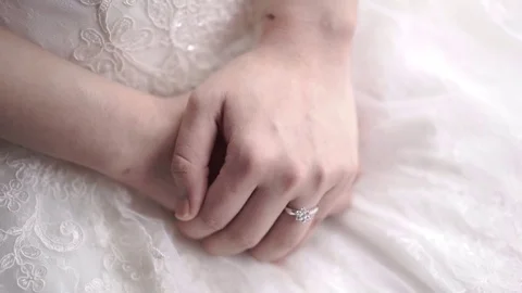 A bride wearing wedding ring sitting and waiting. Close up of a wedding ring Stockbeeldmateriaal 80668945