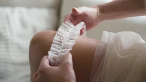 Bride wears garter Stock Footage 147753245