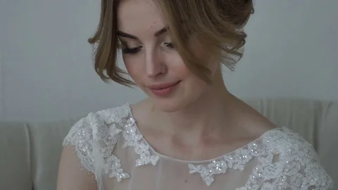 The bride wears a garter on the leg Close-up face Stock Footage 70066239