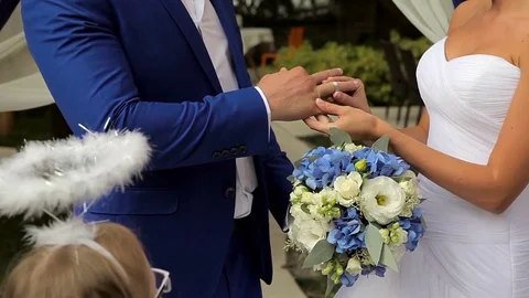The bride wears a ring to the groom Stock Footage 75538809