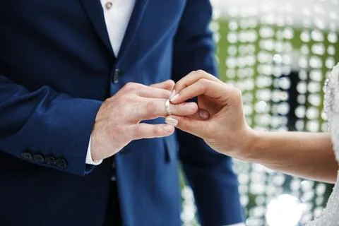 The bride wears a ring to the groom Stock Photos
