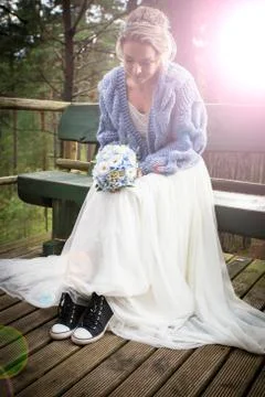 Bride at wedding day with wrong shoes Stock Photos