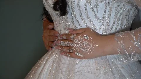 Bride in a wedding dress with a pattern on her hands. Stock Photos