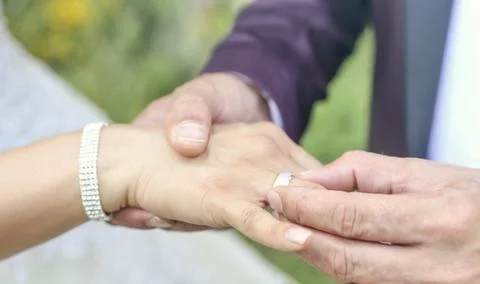 Bride with wedding ring holding hand of groom Stock Photos