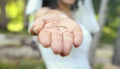 Bride with wedding ring holding hand of groom Stock Photos