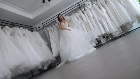 The bride in the wedding salon, she is spinning and the skirt is fluttering. Stock Footage 255636155