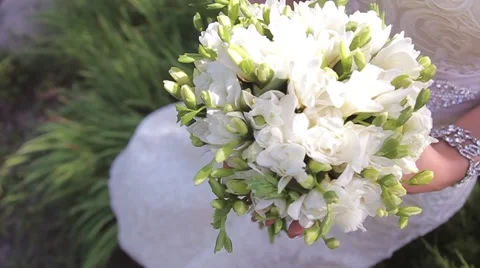 Bride in white dress holding a white bouquet of wedding flowers 스톡 동영상 59169875