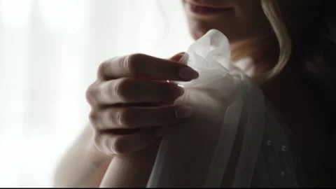 Bride in white dress straightens the bow Stock Footage 194729341