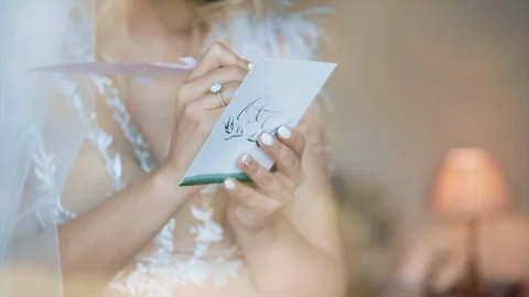 Bride Writes On A Piece Of Paper. Stock Footage 104868684