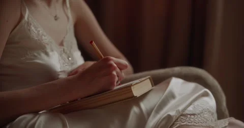 The bride writes the vow for the wedding ceremony for her husband. Video stock 306328716