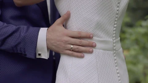 Bridegroom embraces the bride with one hand Stockbeeldmateriaal 84135044