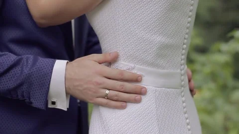 Bridegroom embraces the bride with two hands Stockbeeldmateriaal 84135094