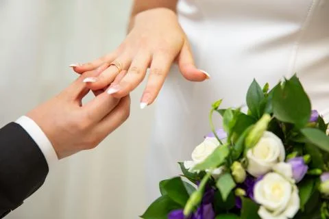 Bridegroom Put the Wedding Ring on bride finger Stock Photos