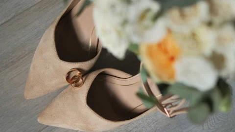 Bride's attributes put together, beautiful shoes, bridal bouquet, wedding rings Stock Footage 236202579