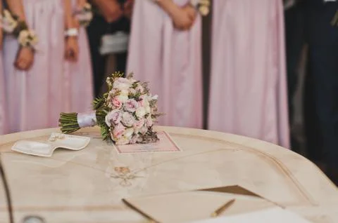 The brides bouquet on the table next to her friends 601. Stock Photos