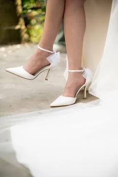 Bride's Elegant White High Heels with Bows Stock Photos