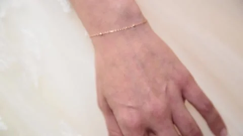 Bride's hand and ring and nice white suit Stock Footage 152303344