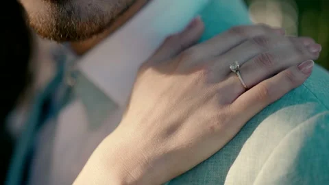 A bride's hand with a beautiful ring goes through the groom's chest. Video stock 227322558