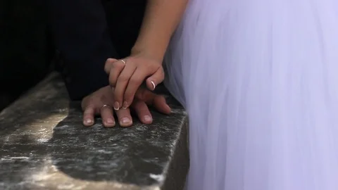 The bride's hand glides gently the arm of the groom Video stock 77588708