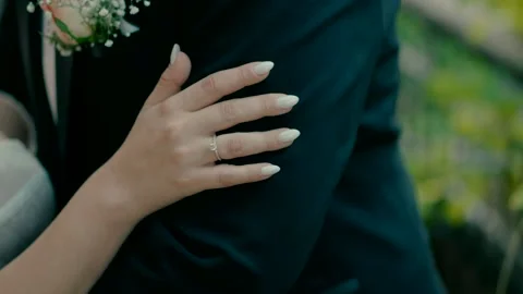 The bride's hand is on the groom's shoulder Stock Footage 220274657