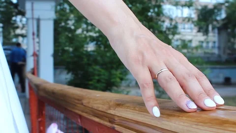 Bride's hand with a ring touching the bridge railing Stock Footage 123348020