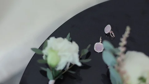 The bride's hand stretches to the earrings Stock Footage 88859413