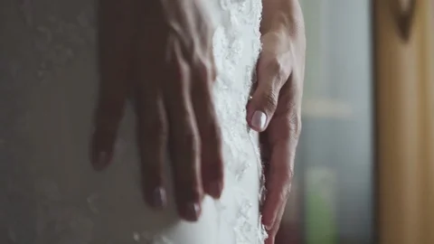Brides hands and her wedding dress Stock Footage 114387613