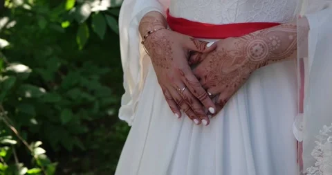 The bride's hands are covered with henna patterns. Stock Footage 221267722