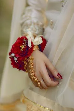Bride's hands with flowers, Elegant bride's hand with a red flowers Stock Photos