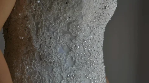 Brides hands move up in front of her beautiful wedding dress Stock Footage 114186092