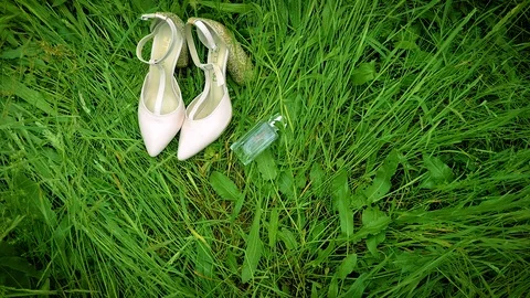 Bride's heels in the grass Stock Footage 90131454