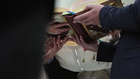 Brides hold a book in front of the priest. Stock Footage 167606485