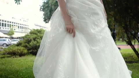 Bride's morning. Hands of a bride close-up lie on a white wedding dress Stock Footage 259394202
