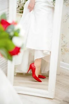 Bride's red shoe Stock Photos