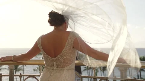 Bride's veil blows in the wind on top of a hotel balcony in Maui Hawaii. Stock Footage 135235791