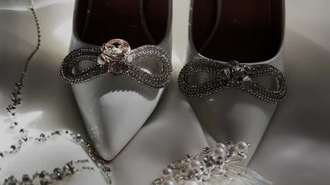 Brides wedding accessories on white fabric Stock Footage 328424413