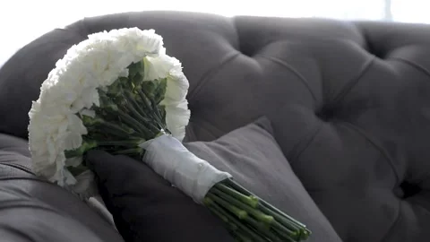 The bride's wedding bouquet is lying on the sofa in daylight. Stock Footage 209685857