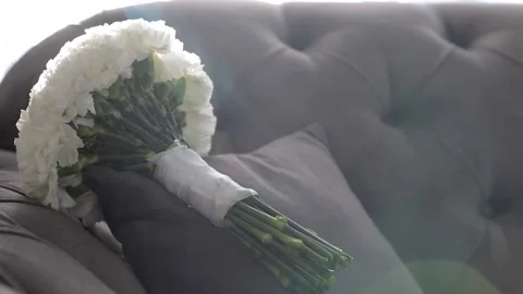 The bride's wedding bouquet is lying on the sofa in daylight. Stock Footage 209686031