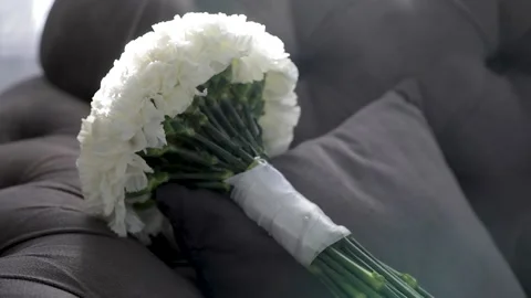 The bride's wedding bouquet is lying on the sofa in daylight. Stock Footage 209686188